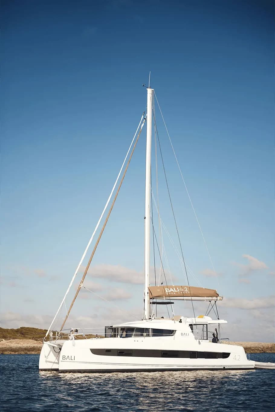 A Bali 4.2 sailing catamaran, the same model as Solanna, at anchor under a blue sky